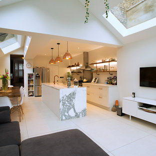 Inspiration for a mid-sized contemporary single-wall separate kitchen in London with a triple-bowl sink, flat-panel cabinets, white cabinets, marble benchtops, stainless steel appliances, with island, white floor and white benchtop.