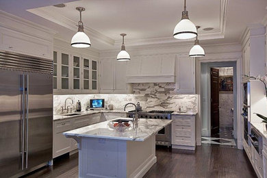 Large trendy u-shaped dark wood floor eat-in kitchen photo in New York with a drop-in sink, glass-front cabinets, white cabinets, marble countertops, gray backsplash, stone slab backsplash, stainless steel appliances and an island