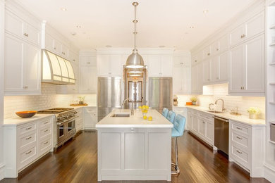 Eat-in kitchen - large transitional u-shaped dark wood floor eat-in kitchen idea in New York with a drop-in sink, recessed-panel cabinets, white cabinets, marble countertops, white backsplash, subway tile backsplash, stainless steel appliances and an island