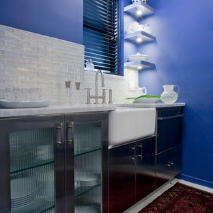 Design ideas for a small contemporary galley separate kitchen in New York with a farmhouse sink, flat-panel cabinets, stainless steel cabinets, marble benchtops, white splashback, glass tile splashback, stainless steel appliances, concrete floors and no island.