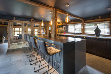 Home bar - large contemporary gray floor home bar idea in Kent with gray countertops