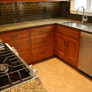 Small eclectic u-shaped separate kitchen in Cedar Rapids with an undermount sink, flat-panel cabinets, medium wood cabinets, recycled glass benchtops, green splashback, glass tile splashback, stainless steel appliances, linoleum floors, no island and yellow floor.
