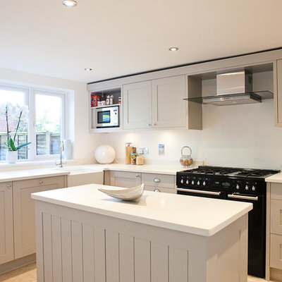 Inspiration for a transitional kitchen remodel in Berkshire with a farmhouse sink, shaker cabinets, beige cabinets and black appliances