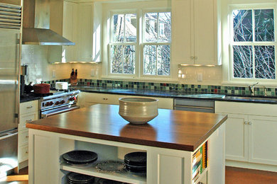 Large transitional l-shaped cork floor eat-in kitchen photo in Boston with an undermount sink, shaker cabinets, white cabinets, soapstone countertops, green backsplash, ceramic backsplash, stainless steel appliances and an island