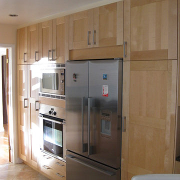 Maple cabinetry with built-in fridge, microwave and wall-oven