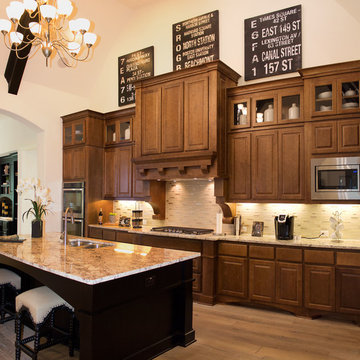 Maple cabinets with medium stain and large custom wood range hood