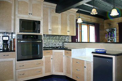 Photo of a modern kitchen in Louisville with flat-panel cabinets.