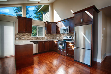 Example of a classic kitchen design in Other with shaker cabinets and dark wood cabinets