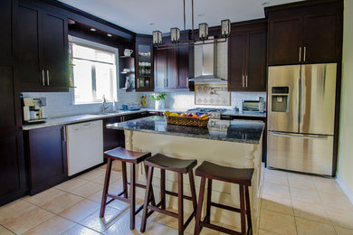 Eat-in kitchen - mid-sized traditional l-shaped ceramic tile and beige floor eat-in kitchen idea in Toronto with an undermount sink, shaker cabinets, granite countertops, white backsplash, ceramic backsplash, stainless steel appliances, an island and dark wood cabinets
