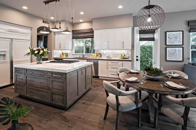 Inspiration for a mid-sized transitional u-shaped open concept kitchen remodel in Orange County with shaker cabinets, white cabinets and an island