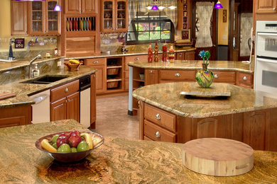 Inspiration for a large timeless travertine floor kitchen remodel in Miami with a double-bowl sink, raised-panel cabinets, light wood cabinets, granite countertops and an island