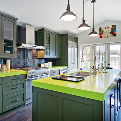 Example of a trendy galley eat-in kitchen design in Los Angeles with a single-bowl sink, shaker cabinets, green cabinets, black backsplash, stainless steel appliances and green countertops