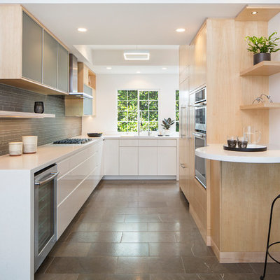 Kitchen - contemporary u-shaped kitchen idea in Los Angeles with an undermount sink, flat-panel cabinets, light wood cabinets, gray backsplash, matchstick tile backsplash, stainless steel appliances, a peninsula and white countertops