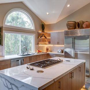 This is an example of a mid-sized transitional l-shaped separate kitchen in San Francisco with flat-panel cabinets, quartz benchtops, stainless steel appliances, porcelain floors, with island, an undermount sink, light wood cabinets, multi-coloured splashback and slate splashback.