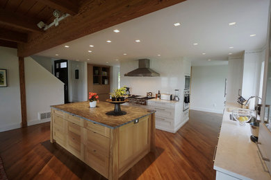 Inspiration for a large transitional u-shaped medium tone wood floor eat-in kitchen remodel in Boston with a single-bowl sink, shaker cabinets, light wood cabinets, quartz countertops, white backsplash, stone slab backsplash, stainless steel appliances and an island