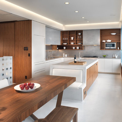 Example of a minimalist l-shaped eat-in kitchen design in San Francisco with open cabinets, medium tone wood cabinets, gray backsplash, paneled appliances and an undermount sink
