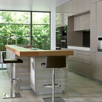 Eat-in kitchen - large contemporary single-wall gray floor and concrete floor eat-in kitchen idea in Dallas with flat-panel cabinets, gray cabinets, an island, an undermount sink, quartz countertops, stainless steel appliances and white countertops