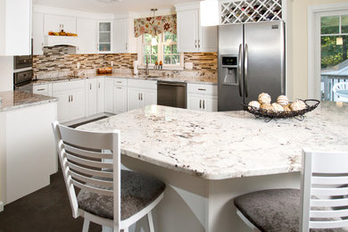 Inspiration for a large modern l-shaped eat-in kitchen remodel in Boston with a single-bowl sink, raised-panel cabinets, white cabinets, granite countertops, multicolored backsplash, glass sheet backsplash, stainless steel appliances and an island