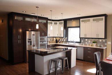 Inspiration for a mid-sized contemporary l-shaped dark wood floor open concept kitchen remodel in Other with an undermount sink, flat-panel cabinets, dark wood cabinets, quartzite countertops, metallic backsplash, mosaic tile backsplash, stainless steel appliances and an island