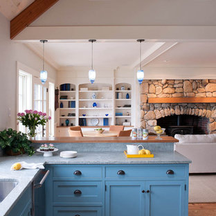Example of a beach style open concept kitchen design in Boston with beaded inset cabinets, blue cabinets and marble countertops