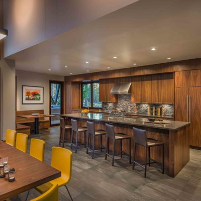 Example of a mountain style galley eat-in kitchen design in Sacramento with flat-panel cabinets, dark wood cabinets, gray backsplash, mosaic tile backsplash and an island