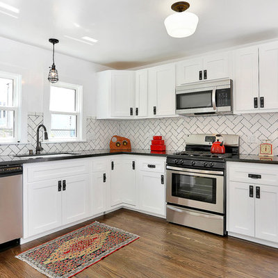Transitional kitchen photo in Los Angeles with an undermount sink, shaker cabinets, white cabinets, granite countertops, white backsplash, subway tile backsplash and stainless steel appliances
