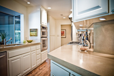 Example of a classic kitchen design in Sacramento with concrete countertops and cement tile backsplash