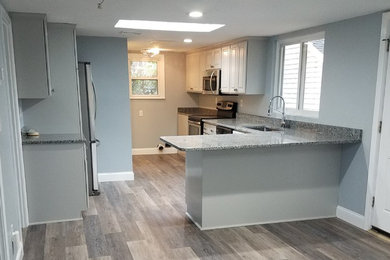 Example of a small classic l-shaped eat-in kitchen design in Boston with raised-panel cabinets, gray cabinets and multicolored countertops