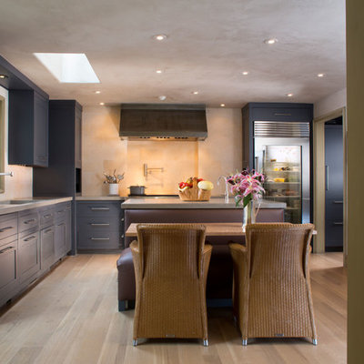 Inspiration for a mediterranean l-shaped eat-in kitchen remodel in DC Metro with concrete countertops, stainless steel appliances, shaker cabinets and blue cabinets