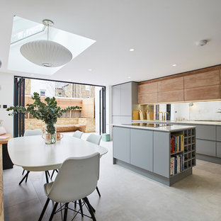 Photo of a medium sized contemporary open plan kitchen in London with an integrated sink, composite countertops, mirror splashback, integrated appliances, ceramic flooring, an island, grey floors, white worktops, flat-panel cabinets and grey cabinets.
