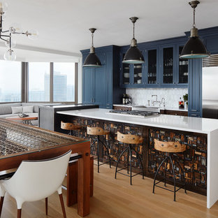 Large eclectic eat-in kitchen designs - Eat-in kitchen - large eclectic light wood floor eat-in kitchen idea in Chicago with a farmhouse sink, recessed-panel cabinets, blue cabinets, quartzite countertops, white backsplash, an island and stainless steel appliances
