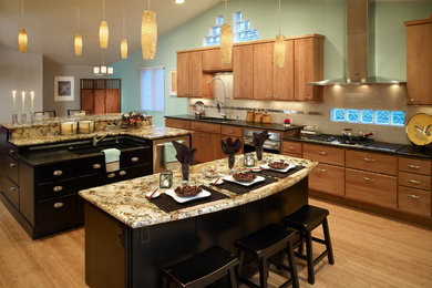 Large trendy single-wall bamboo floor and beige floor eat-in kitchen photo in Denver with an undermount sink, flat-panel cabinets, light wood cabinets, granite countertops, beige backsplash, porcelain backsplash, stainless steel appliances and two islands