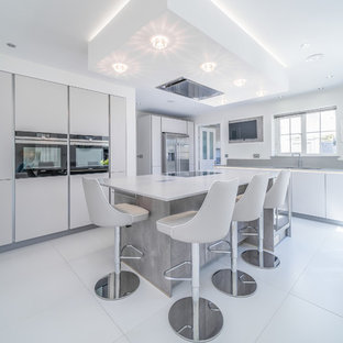 Mid-sized contemporary kitchen in Essex with an integrated sink, grey cabinets, quartzite benchtops, concrete floors, with island, white floor and yellow benchtop.