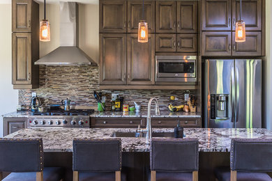 Mid-sized transitional open concept kitchen photo in Toronto with a double-bowl sink, raised-panel cabinets, dark wood cabinets, marble countertops, multicolored backsplash, matchstick tile backsplash, stainless steel appliances and an island