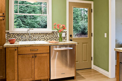 Inspiration for a mid-sized timeless u-shaped light wood floor and brown floor enclosed kitchen remodel in Seattle with a double-bowl sink, shaker cabinets, medium tone wood cabinets, quartz countertops, multicolored backsplash, mosaic tile backsplash, stainless steel appliances, no island and multicolored countertops