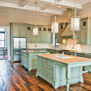 Design ideas for an expansive traditional l-shaped open plan kitchen in Other with a farmhouse sink, recessed-panel cabinets, green cabinets, marble benchtops, multi-coloured splashback, ceramic splashback, stainless steel appliances, multiple islands, ceramic floors and brown floor.