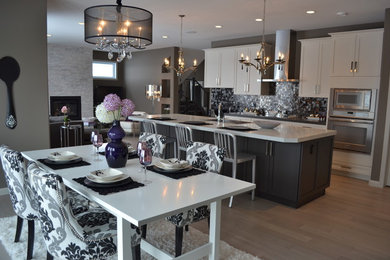 Transitional open concept kitchen photo in Calgary with stainless steel appliances, black backsplash, mosaic tile backsplash, recessed-panel cabinets and white cabinets