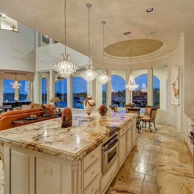 Open concept kitchen - mediterranean l-shaped beige floor open concept kitchen idea in Dallas with raised-panel cabinets, beige cabinets, granite countertops, beige backsplash, stainless steel appliances and an island