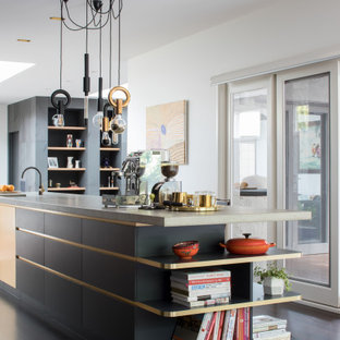 This is an example of a large contemporary kitchen in Melbourne with an integrated sink, flat-panel cabinets, black cabinets, dark hardwood floors, with island, brown floor and grey benchtop.
