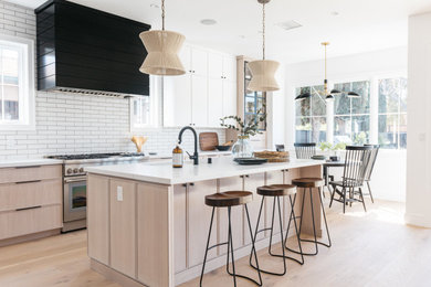 Large l-shaped open concept kitchen photo in Los Angeles with quartz countertops and an island
