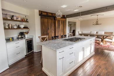 Eat-in kitchen - mid-sized transitional galley dark wood floor and brown floor eat-in kitchen idea in DC Metro with a farmhouse sink, shaker cabinets, white cabinets, marble countertops, stainless steel appliances and an island