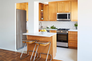 Small 1960s l-shaped porcelain tile eat-in kitchen photo in New York with an undermount sink, shaker cabinets, orange cabinets, quartzite countertops, white backsplash, ceramic backsplash, stainless steel appliances and an island