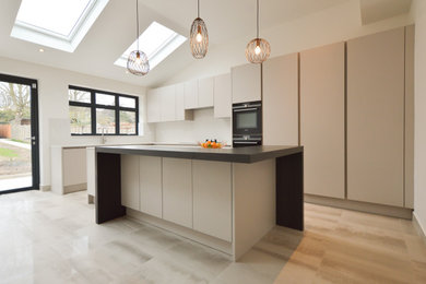 Inspiration for a large modern single-wall open plan kitchen in London with a built-in sink, flat-panel cabinets, quartz worktops, stone slab splashback, integrated appliances, porcelain flooring and an island.