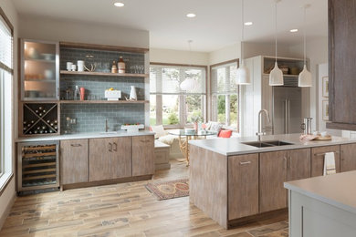 Inspiration for a large contemporary single-wall kitchen/diner in Minneapolis with a double-bowl sink, flat-panel cabinets, distressed cabinets, engineered stone countertops, blue splashback, metro tiled splashback, stainless steel appliances, an island, medium hardwood flooring, beige floors and white worktops.