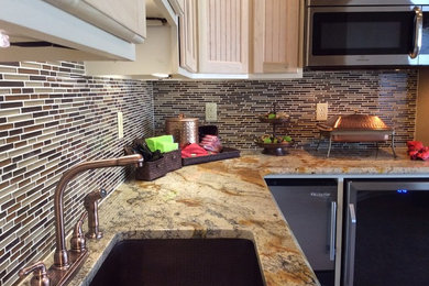 Large transitional u-shaped carpeted eat-in kitchen photo in Other with a single-bowl sink, louvered cabinets, light wood cabinets, granite countertops, multicolored backsplash, matchstick tile backsplash and stainless steel appliances