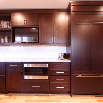 Medium Stained Kitchen with Subzero Wolf Appliances and White Subway Tile