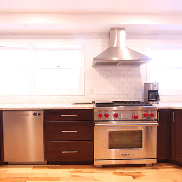 Medium Stained Kitchen with Subzero Wolf Appliances and White Subway Tile