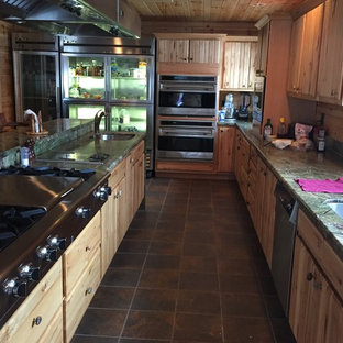 Large country l-shaped eat-in kitchen in Other with a double-bowl sink, louvered cabinets, light wood cabinets, granite benchtops, stainless steel appliances, slate floors, with island and multi-coloured floor.
