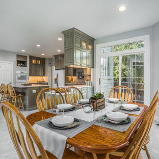 Mid-sized traditional eat-in kitchen ideas - Mid-sized elegant u-shaped gray floor eat-in kitchen photo in DC Metro with raised-panel cabinets, gray cabinets, gray backsplash, white appliances, an island and gray countertops