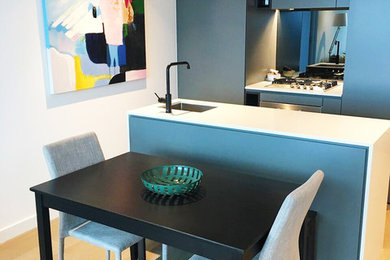 Photo of a small modern galley kitchen/diner in Melbourne with an island.